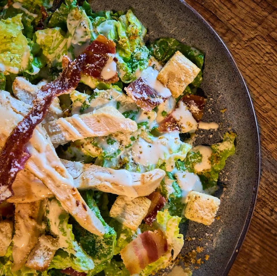 Chicken Caesar salad with crispy bacon and croutons