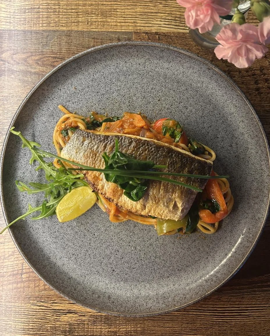 Grilled sea bass on a bed of Mediterranean vegetables