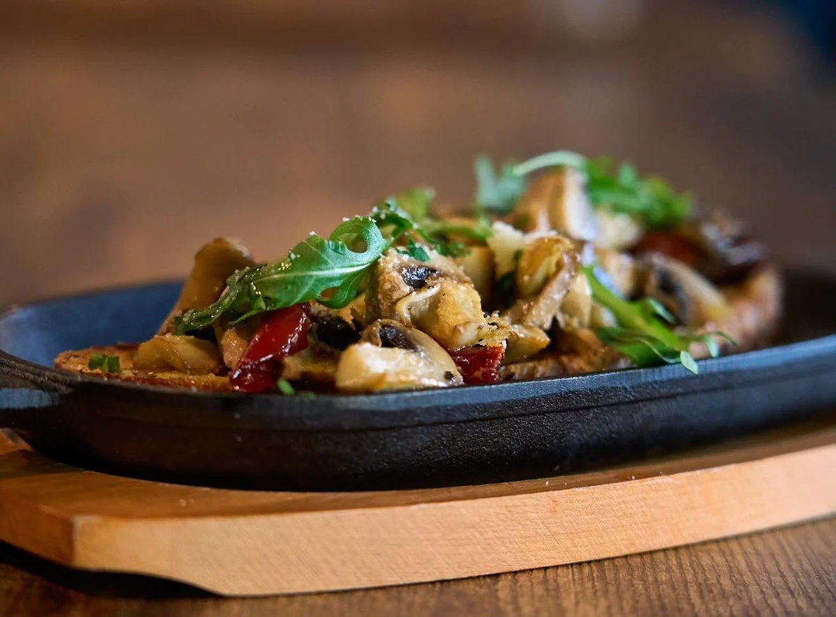 Sautéed garlic mushrooms served in a skillet